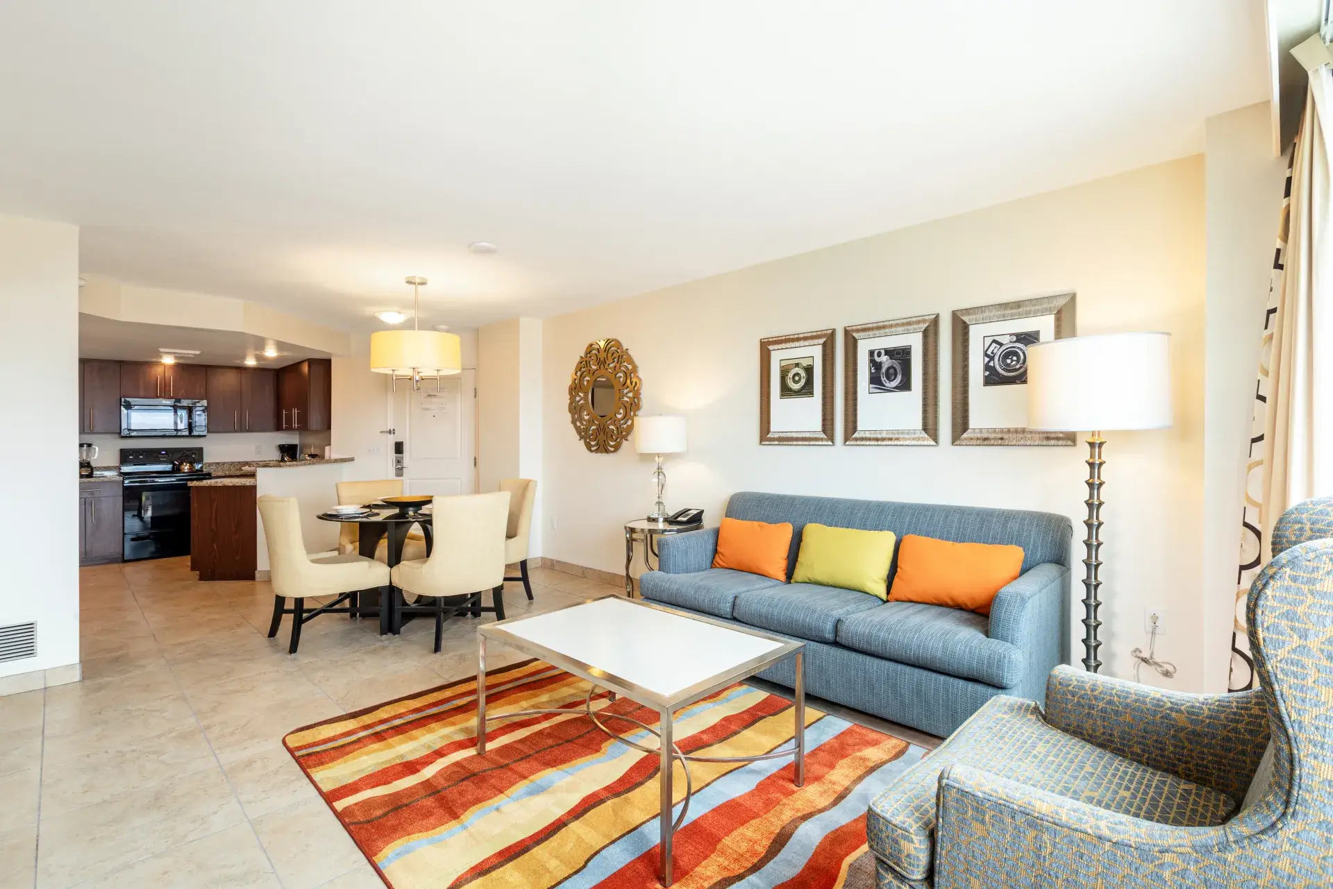 Spacious suite living room with sofa, TV, and natural light