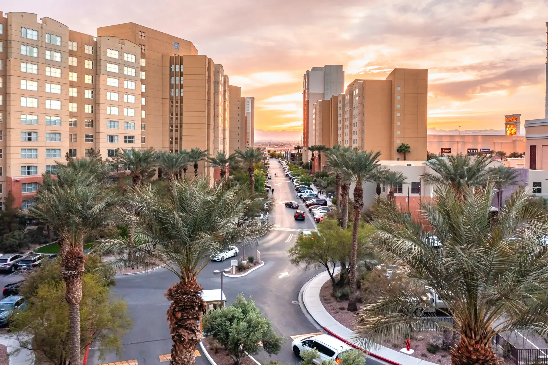 Exterior view of The Grandview at Las Vegas at dusk with palm-lined entrance and resort buildings